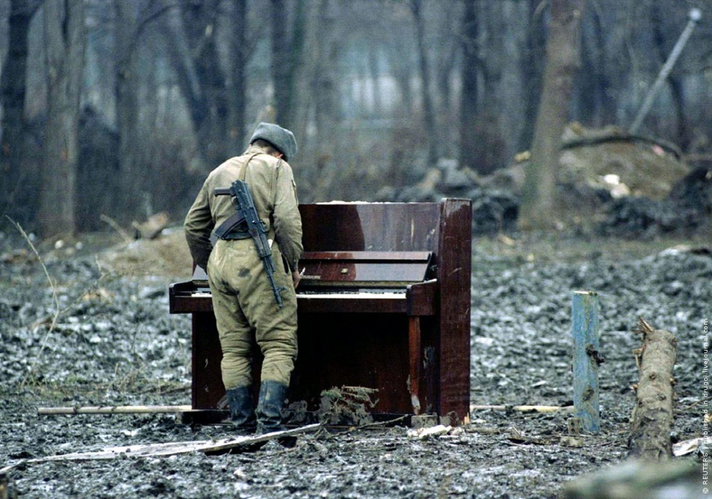 Russian soldier playing an abandoned piano